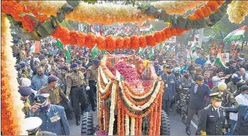  ?? ?? Huge crowd gather during the funeral procession of Gen Bipin Rawat from his residence to Brar Square in New Delhi on Friday.