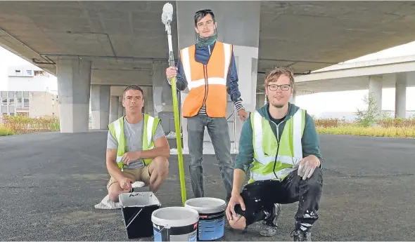  ??  ?? Technical assistant John O’Meara, 41, and artists Martin McGuinness, 29, and Fraser Gray, 30, who are livening up the Tay Road Bridge ramp columns.