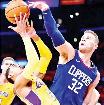  ?? — AFP photo ?? Blake Griffin (R) of the LA Clippers knocks the ball away from Jordan Clarkson of the Los Angeles Lakers in a 108-92 Clipper win during the Los Angeles Lakers home opener at Staples Center on October 19, 2017 in Los Angeles, California.