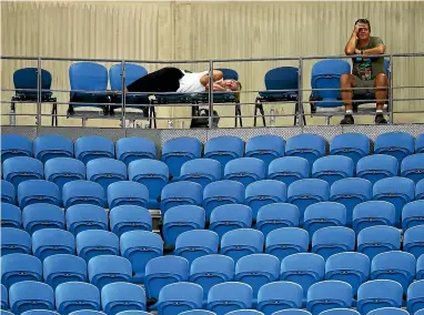  ?? GETTY IMAGES ?? One fan laid across three seats for a sleep as an Australian Open match went on into the early hours of yesterday morning.