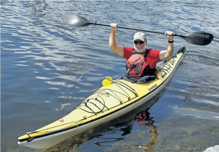  ?? CLIFFORD SKARSTEDT/EXAMINER ?? Kayaker Hugh Dobson celebrates on the Trent-Severn Waterway Thursday afternoon after completing his marathon 48-day, 1,426-kilometre trek from Thunder Bay to Lakefield by kayak.