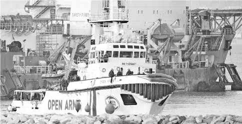  ??  ?? The ship of Spanish NGO Proactiva Open Arms arrives in the southern Spanish port of Algeciras in Campamento near San Roque, with 311 migrants on board. — AFP photo