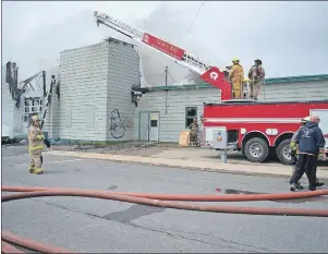  ?? NIKKI SULLIVAN/CAPE BRETON POST ?? By 11 a.m. on Sunday, the flames weren’t as visible from the outside but were still blazing inside as the front part of the former St. Agnes School in New Waterford started to collapse.