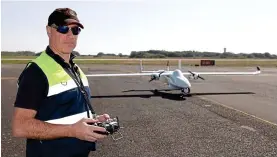  ??  ?? Ground control: Drone pilot Phil Mousley lands one of the aircraft