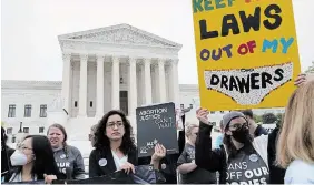  ?? JOSE LUIS MAGANA THE ASSOCIATED PRESS ?? Demonstrat­ors protest outside of the U.S. Supreme Court Tuesday in Washington. A draft opinion suggests the court could be poised to overturn the 1973 Roe v. Wade case that legalized abortion nationwide, according to a Politico report released Monday.