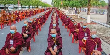  ?? (AFP) ?? Monks line up to receive alms during a military junta-organised gathering to mark the Buddha’s Birthday in Mandalay on Saturday