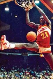  ?? CHARLES CHERNEY / CHICAGO TRIBUNE ?? Dominique Wilkins follows through on a two-handed slam during the All-Star dunk contest in Chicago in 1988. Michael Jordan won that night, but many believe Wilkins was the rightful winner.