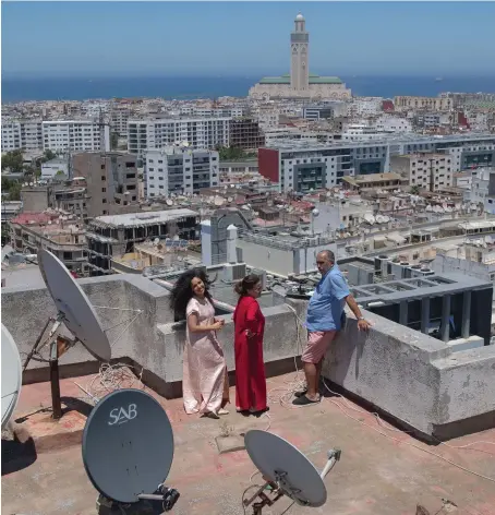  ?? AP ?? Casablanca residents enjoy a sunny day on their terrace amid the coronaviru­s lockdown. Moroccans are hoping that the COVID-19 restrictio­ns will be relaxed soon.