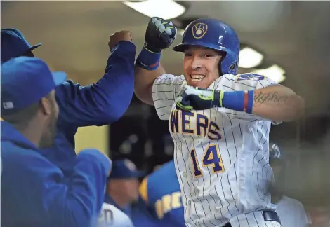  ?? ASSOCIATED PRESS ?? Hernán Pérez celebrates with teammates after his third-inning home run gave the Brewers a 2-0 lead over the Mets on Friday night at Miller Park.