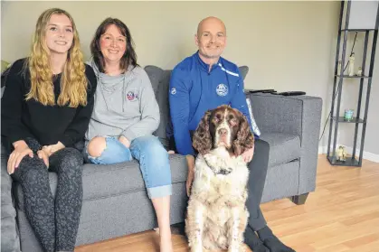  ?? JASON SIMMONDS • JOURNAL PIONEER ?? Noah Dobson’s family settles in to watch Game 4 between the New York Islanders and Pittsburgh Penguins on May 22 from their home in Summerside. From left are Elly, Jenny and Andrew Dobson, along with Dreyfus, the family dog.
