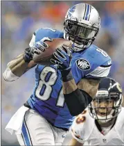  ?? GREGORY SHAMUS / GETTY IMAGES ?? Lions star Calvin Johnson had 11 catches and became the fastest player to 10,000 receiving yards, reaching the milestone in his 115th game.