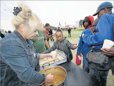  ?? Picture: ATHENA O’REILLY ?? MAKING A DIFFERENCE: After feeling sad when he saw homeless people roaming around at Eastern Beach, 10-year-old Luthando Matiwane decided to help them by serving soup and bread and something warm to wear during the approachin­g cold months. Tracey...