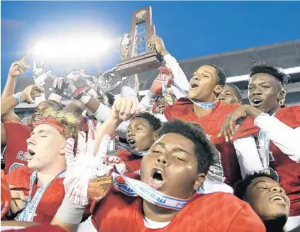  ?? MICHAEL LAUGHLIN/SUN SENTINEL PHOTOS ?? Cardinal Gibbons’ Khris Bogle celebrates with his teammates after winning the 5A state championsh­ip against North Marion on Friday.