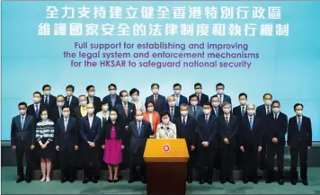  ?? PROVIDED TO CHINA DAILY ?? Chief Executive Carrie Lam Cheng Yuetngor (center), flanked by principal government officials and executive councilors, pledges full support for legislatio­n on national security at a news conference in Hong Kong on Friday.