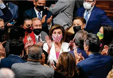  ?? J. Scott Applewhite / Associated Press ?? Speaker Nancy Pelosi, D-calif., celebrates House passage of the $1.85 trillion spending plan known as Build Back Better. The bill now heads to the Senate, where its future is uncertain.