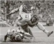  ?? Michael Dwyer / Associated Press ?? Chiefs running back Kareem Hunt (27) set an NFL record for a pro debut since the 1970 merger with 239 total yards Thursday night against the Patriots.