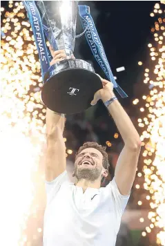  ??  ?? Grigor Dimitrov claimed the biggest title of his career by edging a three-set thriller with David Goffin to win the ATP Finals in London. The Bulgarian defeated Goffin 7-5 4-6 6-3 at the O2.