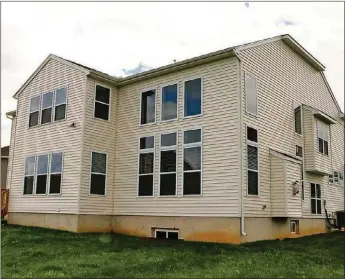  ??  ?? A 2-story great room has walls of windows that also add natural light to the upstairs loft family room. The basement has been finished to include a media room, a recreation room with wet bar, a full bathroom and a bedroom with an egress window.