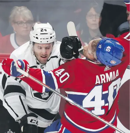  ?? PIERRE OBENDRAUF ?? Los Angeles Kings defenceman Derek Forbort gives Montreal Canadiens forward Joel Armia a rough ride Thursday during the Canadiens’ home opener at Bell Centre. The Habs outshot the Kings 40-29, but goalie Jack Campbell was perfect in the L.A. net for a 3-0 shutout.