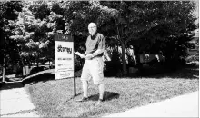  ?? NATHAN DENETTE THE CANADIAN PRESS ?? Donald Bergeron poses for a photograph with a personaliz­ed letter which he and his family received as part an offer to buy his house in Toronto. Writing letters in the offer process is becoming a growing tactic for buyers.