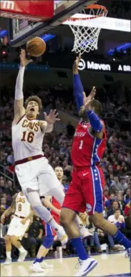  ?? CHRIS SZAGOLA — ASSOCIATED PRESS ?? Cedi Osman, left, shoots as the 76ers’ Mike Scott defends during the second half March 12in Philadelph­ia.