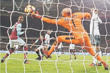  ??  ?? Juan Mata (centre) scores the opening goal past West Ham United’s Irish goalkeeper Darren Randolph during the English Premier League football match between West Ham United and Manchester United at The London Stadium, in east London. — AFP PHOTO