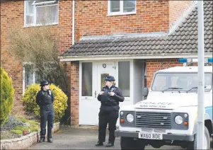  ?? AP PHOTO ?? In this March 6 file photo, police officers stand outside the house of former Russian double agent Sergei Skripal in Salisbury, England. British police say they believe a Russian ex-spy and his daughter first came into contact with a military-grade...