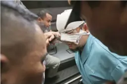  ??  ?? JAKARTA: Indonesian Corruption Eradicatio­n Commission (KPK) investigat­or Novel Baswedan (center) who was injured in an attacked by unidentifi­ed assailants is assisted by officials and police officers as he leaves the general hospital yesterday. — AP