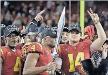  ?? [MARCIO JOSE SANCHEZ/THE ASSOCIATED PRESS] ?? Quarterbac­k Sam Darnold, right, and his USC teammates celebrate after defeating Stanford 31-28 in the Pac-12 championsh­ip game Friday. The Trojans and Buckeyes, longtime Rose Bowl combatants, will meet in the Cotton Bowl this time.