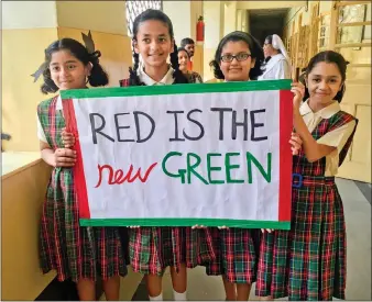  ??  ?? School girls celebratin­g after the installati­on of a sanitary vending machine in Auxilium Convent in Mumbai.