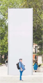  ?? TOLGA AKMEN / AFP VIA GETTY IMAGES ?? A worker cleans graffiti from the statue of Winston Churchill at Parliament Square in London on June 8. Authoritie­s have since boarded up the statue amid fears of violent clashes between anti-racism protesters and far-right groups.