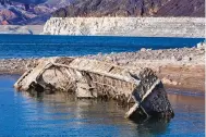  ?? L.E. BASKOW/LAS VEGAS REVIEW-JOURNAL VIA AP ?? A WWII-era landing craft used to transport troops or tanks was revealed on the shoreline near the Lake Mead Marina on Thursday as the waterline continues to lower.