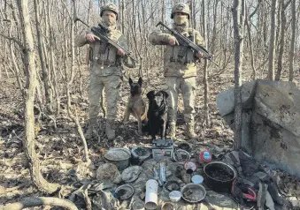  ?? ?? Two soldiers stand guard over materials seized in a PKK hideout in eastern Bingöl province, Türkiye, March 5, 2024.