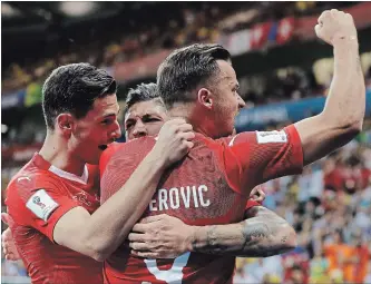  ?? THEMBA HADEBE THE ASSOCIATED PRESS ?? Switzerlan­d’s Steven Zuber, back, celebrates with teammates after scoring his side’s goal.