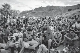  ?? REUTERS ?? Hondurans taking part in a new caravan of migrants, set to head to the United States, rest on a road, in Vado Hondo, Guatemala on Sunday.
