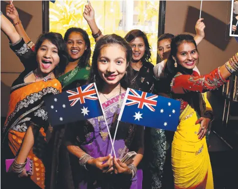  ?? Picture: JUSTIN BRIERTY ?? WARM WELCOME: Former Bhutanese residents Yoba Basnet and Purni Chhetri celebrate their friends Gita Bhandari, Manju Bista, Gayatri Dahal and Tika Sanyasi’s Australian citizenshi­p.