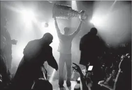  ?? Robert Gauthier Los Angeles Times ?? BASKING IN championsh­ip glory in 2007, Jean-Sebastien Giguere, then the Ducks’ goalie, hoists the Stanley Cup during an appearance at a Canadian club.