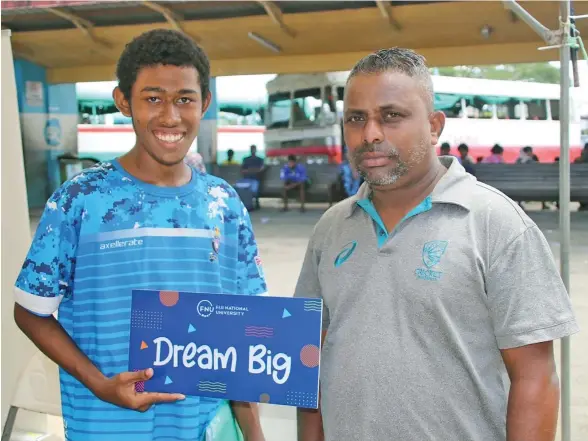  ?? ?? From right: A.D. Patel College teacher Vishwa Achari with Mosese Poe to enroll at the Fiji National University’s (FNU) Enrolment Roadshow at the Ba Bus Stand last weekend.