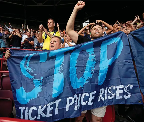  ?? GETTY IMAGES ?? Enough is enough: Spurs supporters protest about the soaring cost of tickets on the first weekend of the season