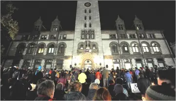  ??  ?? Community members hold candles at a vigil for the victims of the Pittsburgh Synagogue shooting at Cambridge City Hall in Cambridge, Massachuse­tts. — AFP photo