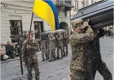  ?? FRANCISCO SECO THE ASSOCIATED PRESS ?? Soldiers carry the coffins of two Ukrainian army sergeants during their funeral at the Saints Peter and Paul Garrison Church in Lviv, Ukraine, on Tuesday. Ukraine is calling for renewed support at a time when it looks more and more vulnerable, Alec Rogers writes.