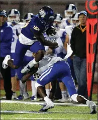  ?? Arkansas Democrat-Gazette/THOMAS METTHE ?? North Little Rock running back Oscar Adaway hurdles a Bryant defender during the third quarter Friday.