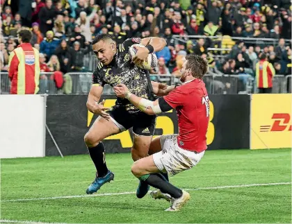  ?? PHOTO: MARK TANTRUM/GETTY IMAGES ?? Ngani Laumape of the Hurricanes breaks the tackle of Dan Biggar during their match against the British & Irish Lions at Westpac Stadium in Wellington on Tuesday night.