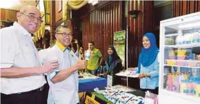  ??  ?? Perlis Menteri Besar Datuk Seri Azlan Man (centre) and the Northern Corridor Implementa­tion Authority (NCIA) chief executive Datuk Redza Rafiq (left) checking out a dairy product produced by one of the recipients of Bumiputera Micro Developmen­t Grant...