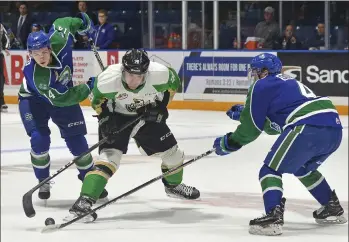  ?? STEVEN MAH/SOUTHWEST BOOSTER ?? Forward Ben King (left) and defenseman Billy Sowa (right) combined to slow down Prince Albert’s Kody Mcdonald during a 3-2 shootout win last week.