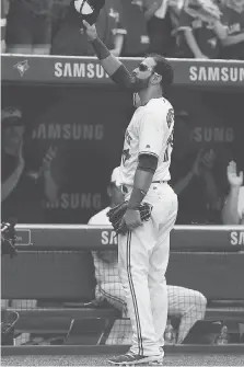  ?? VAUGHN RIDLEY/GETTY IMAGES ?? Toronto Blue Jays outfielder Jose Bautista tips his hat to the fans after he is pulled from the game in the ninth inning in Toronto on Sunday. The Jays beat the New York Yankees 9-5.