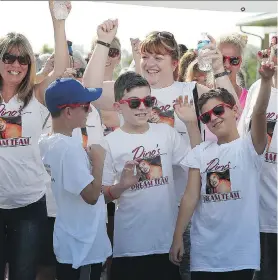  ?? NICK BRANCACCIO ?? Ben Farina, 12, centre, and his mother, Sandi Farina, behind, are surrounded by friends and family as Dino’s Dream Team prepares for the seventh annual Windsor/Essex County Multiple Myeloma March on Sunday.
