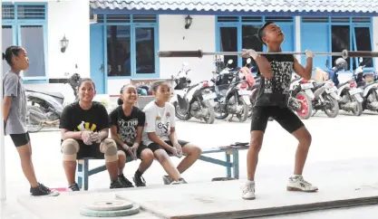  ??  ?? LAMPUNG: This photo taken on November 7, 2016 shows young weightlift­ers training at the ‘elephant club’, a private academy in Pringsewu, a regency of Lampung in Southern Sumatra. Many of Indonesia’s sporting legends were bred in small-town clubs,...