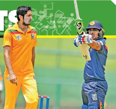  ?? ?? Colombo's Shehan Jayasuriya, who hit a timely ton, gestures to the dressing room after reaching 100 runs