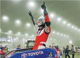  ?? [PHOTO BY JESSIE WARDARSKI, TULSA WORLD] ?? Christophe­r Bell of Norman celebrates his Chili Bowl Nationals victory on Saturday night in Tulsa. Bell has won the prestigiou­s indoor race two consecutiv­e years.
